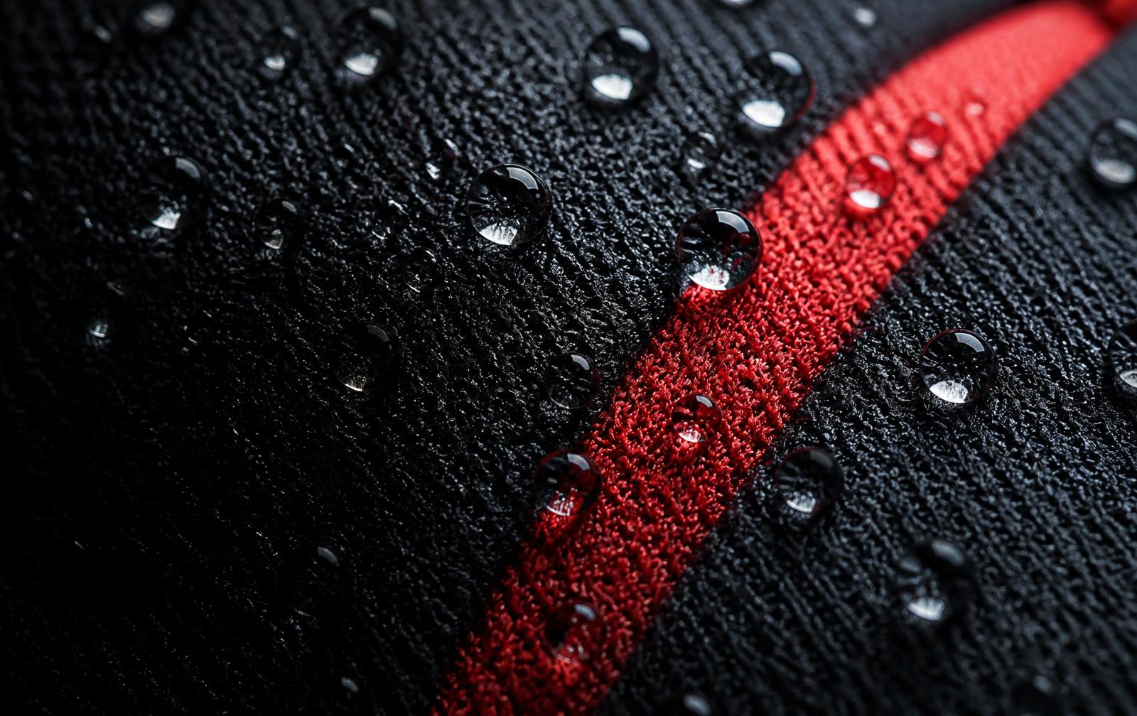 Close detail of technical jersey fabric with a red stripe