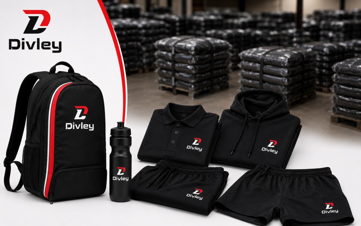 Divley premium range laid out on a light surface — black backpack with red and white stripes, water bottle, folded polo, hoodie, joggers and shorts with Divley branding